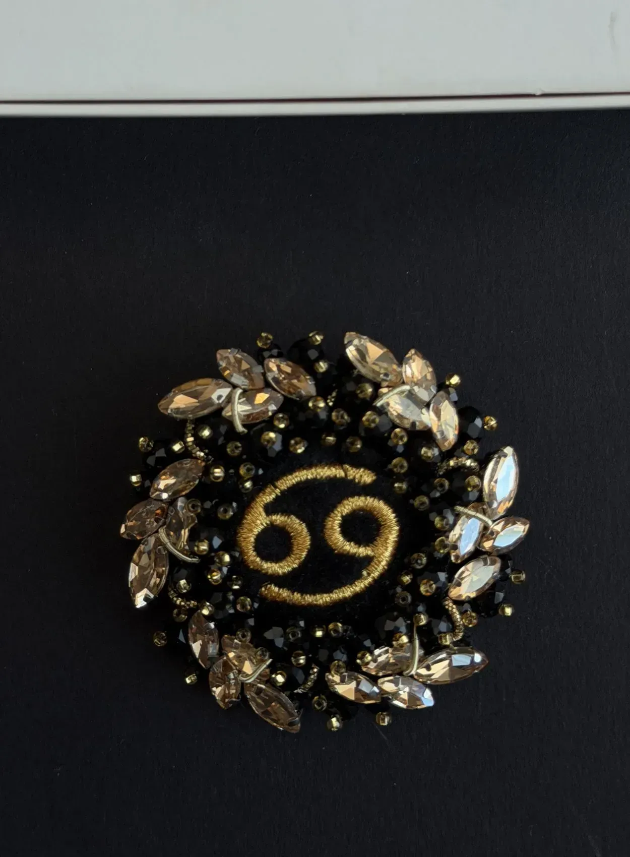 Brooch "Cancer" in a golden wreath